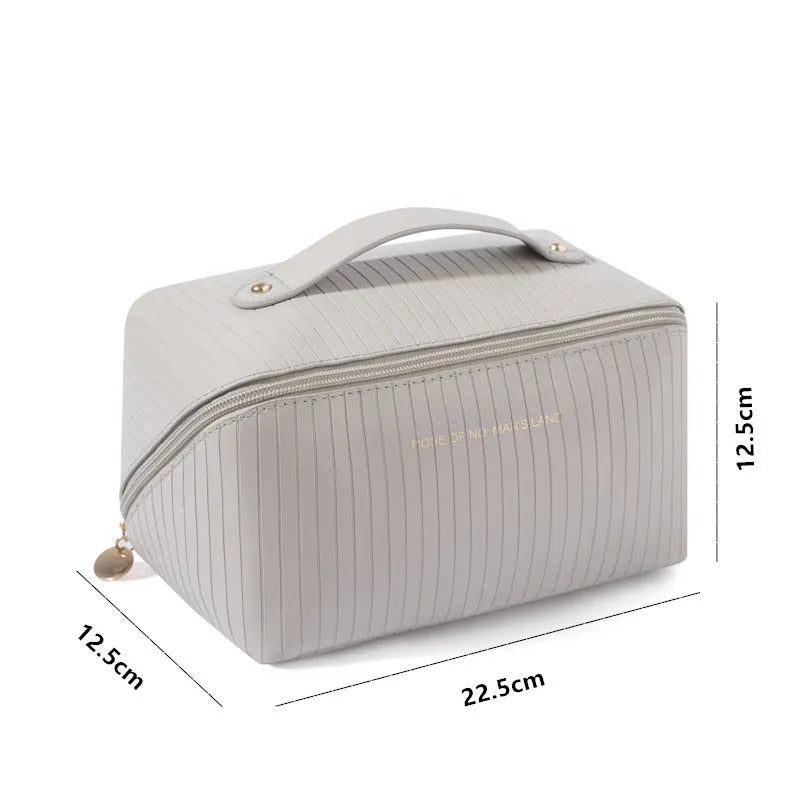 Vertical stripe pattern cubic makeup bag in PU material measuring 22.5cm wide