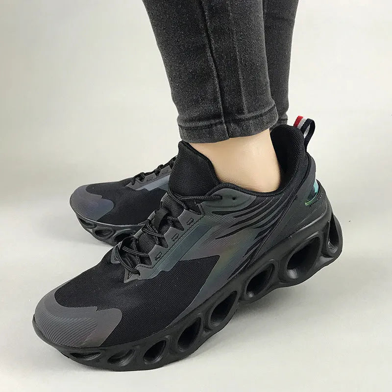 Casual low-top sports shoes in black with mesh upper, round toe, and white EVA sole on a plain background.