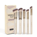 MAANGE set of five apricot-coloured makeup brushes with an angled blush brush on a grey background.