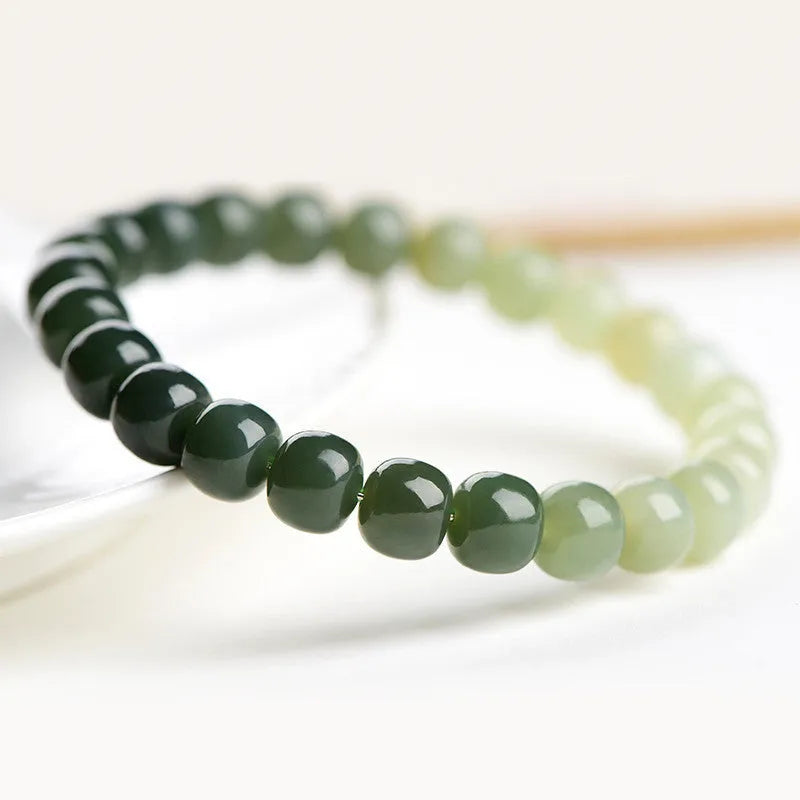 Natural Hetian jade bracelet with water gradient colour on polished beads, unisex casual style.