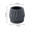 A simple grey ceramic flowerpot, medium-sized, for tabletop or floor plants.