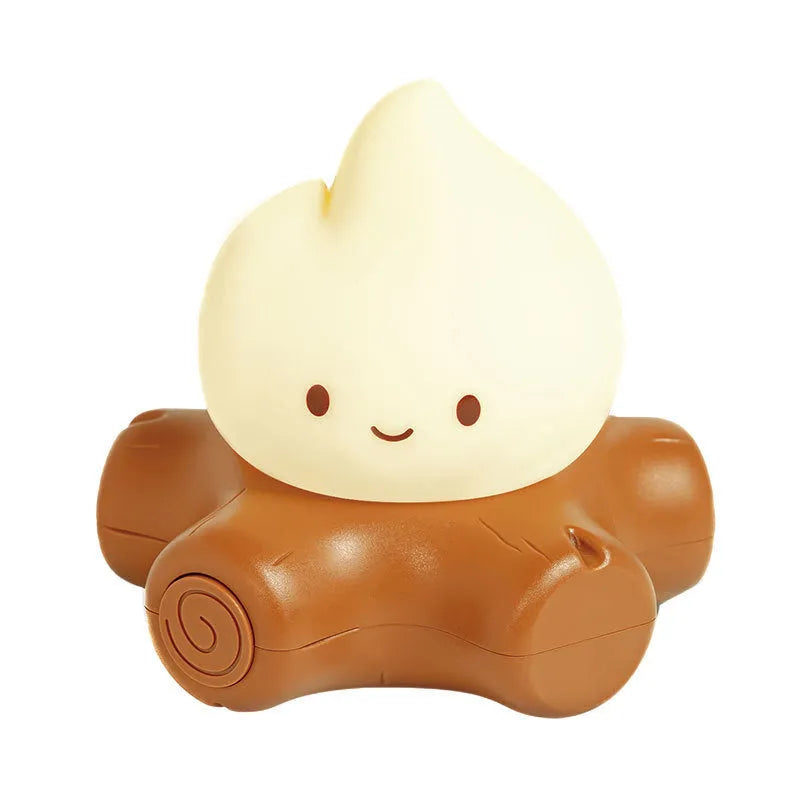 Small yellow silicone cartoon fire pile night lamp with ABS plastic shade on a table