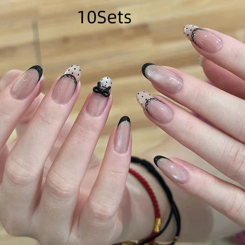 A selection of false nails in various colours and sweet girl style patterns, shown in packs of 5, 10, or 15 sets.