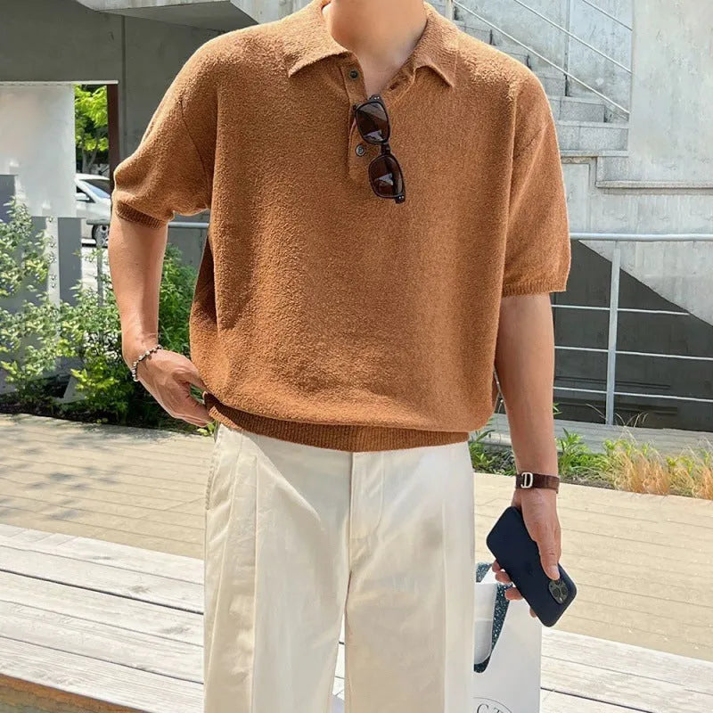 A caramel-colour men's retro knitted polo shirt with short sleeves, showing its loose fit and asymmetric design detail.