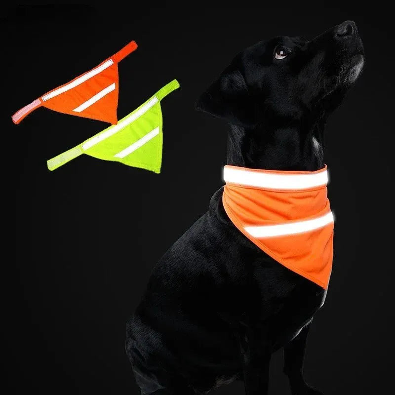 Yellow and orange polyester dog bandana with reflective stripes laid flat, showing adhesive strap closure.