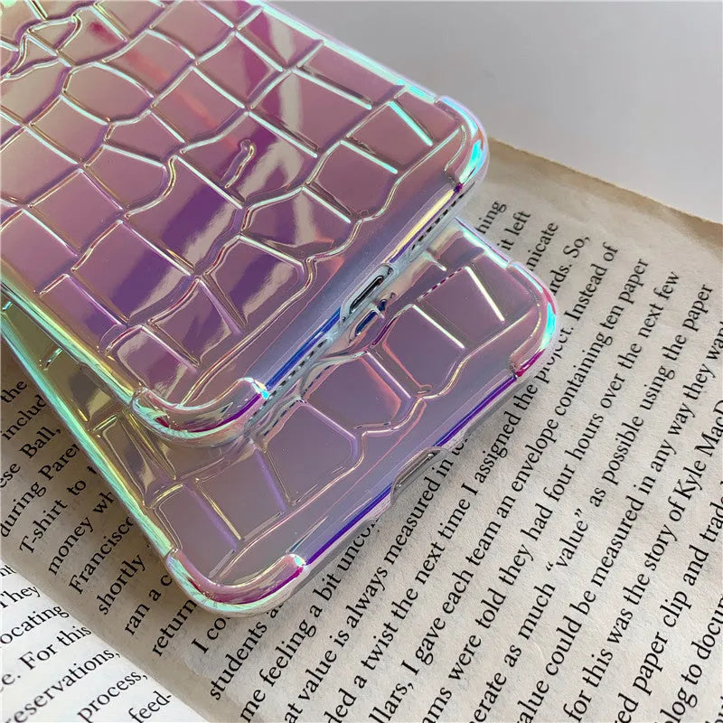 Silver glossy laser design silicone case for iPhone on a table.