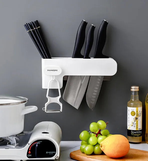 White plastic kitchen knife rack organiser with modern simple design on a countertop.