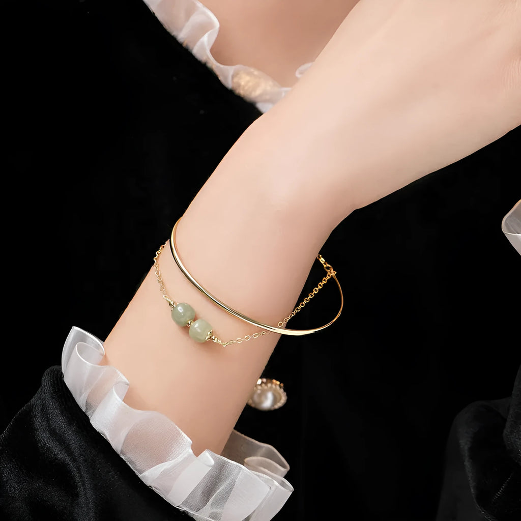 Women's jade bracelet with gold inlay lucky bead design in single, double, or three bead versions.
