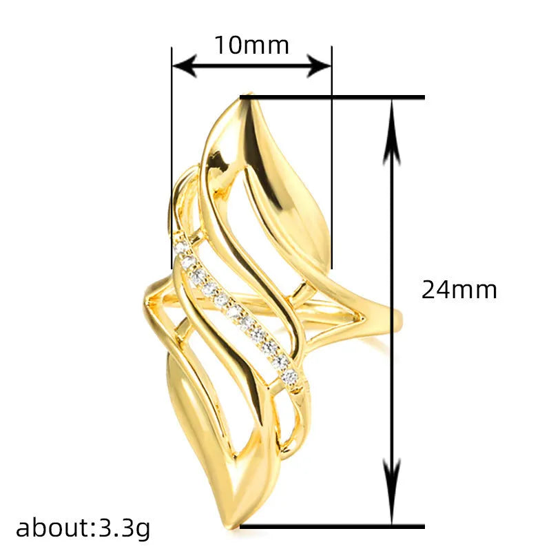 Gold-colour women's ring with exaggerated curved design and zircon crystal detail on a copper band.