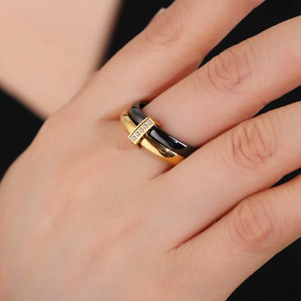 Glossy titanium steel women's ring with heart shape formed by a double band and zirconium inlay.