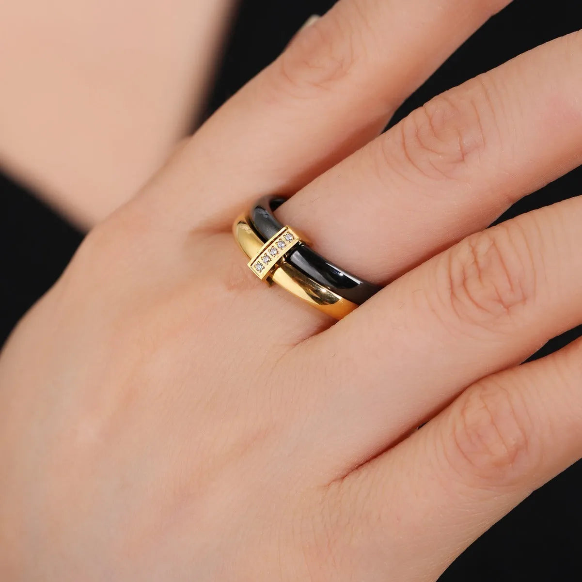 Glossy titanium steel women's ring with heart shape formed by a double band and zirconium inlay.