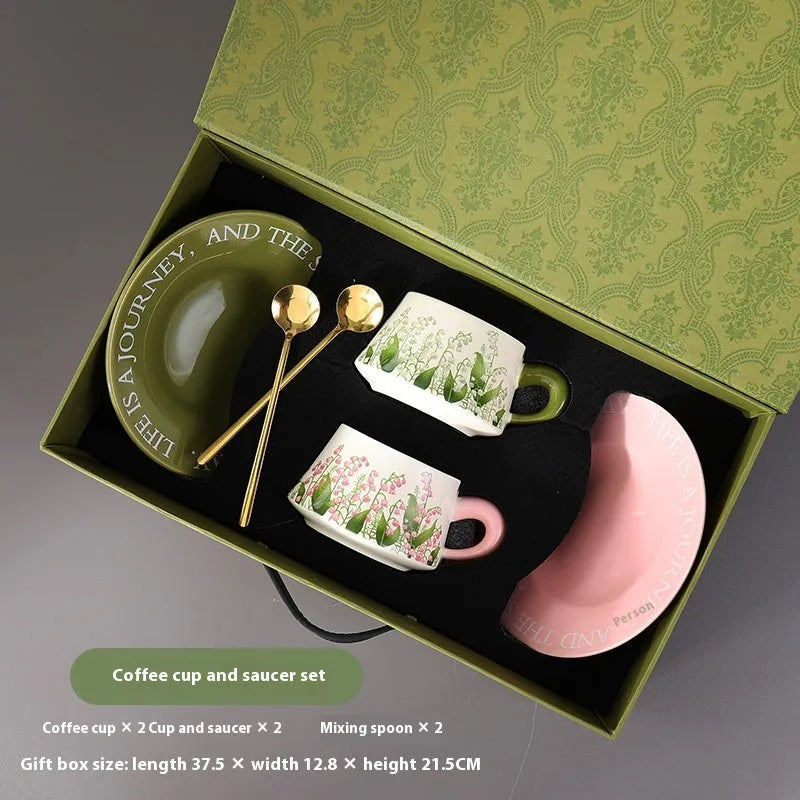 Ceramic coffee cup and saucer set for two with stirring spoons in Hanging Bell or Lanling Grass patterns.