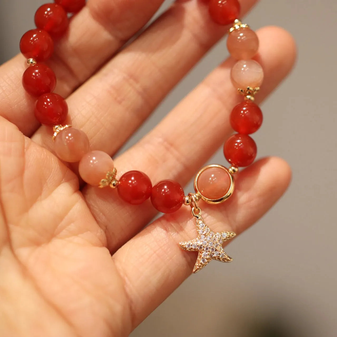 Handmade women's red agate bracelet with 8mm stones and ethnic star design featuring Xiangyun elements
