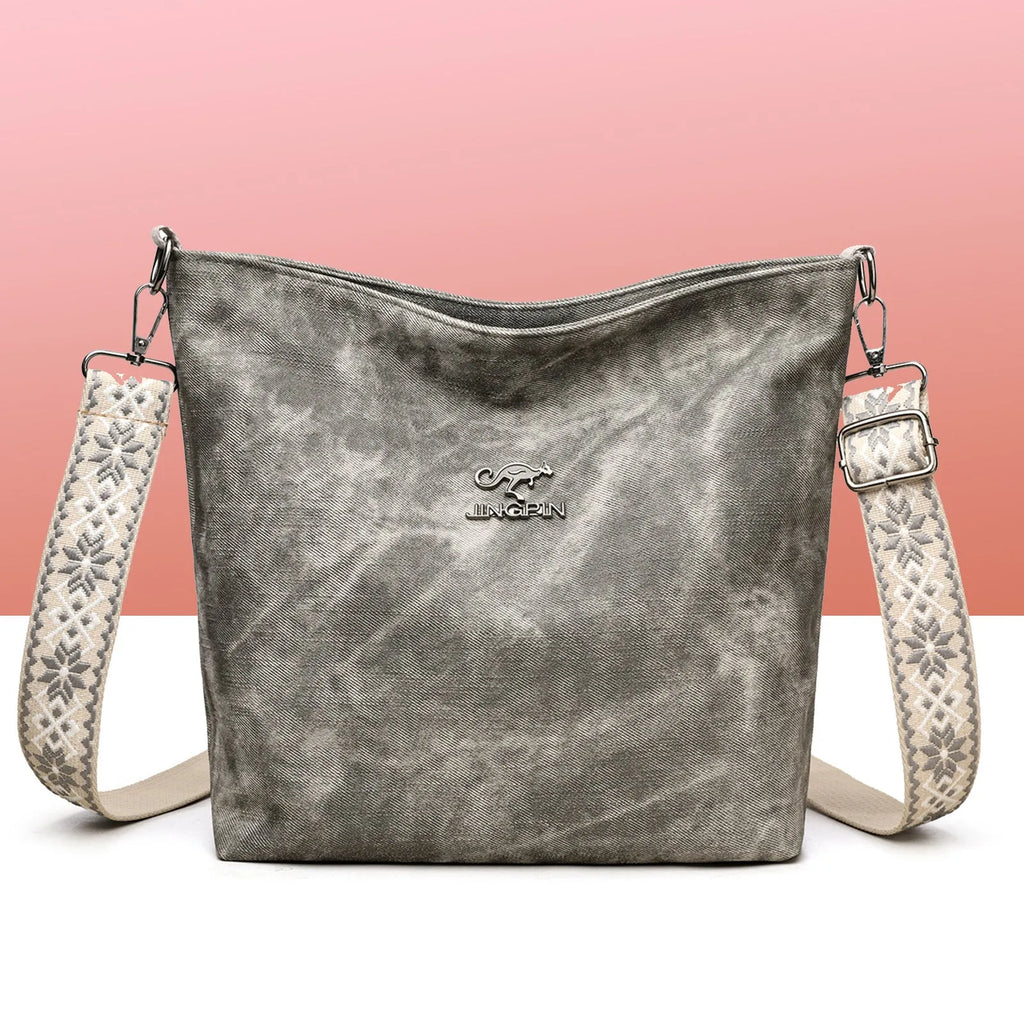 Soft grey PU crossbody bag with a large main compartment and adjustable shoulder strap