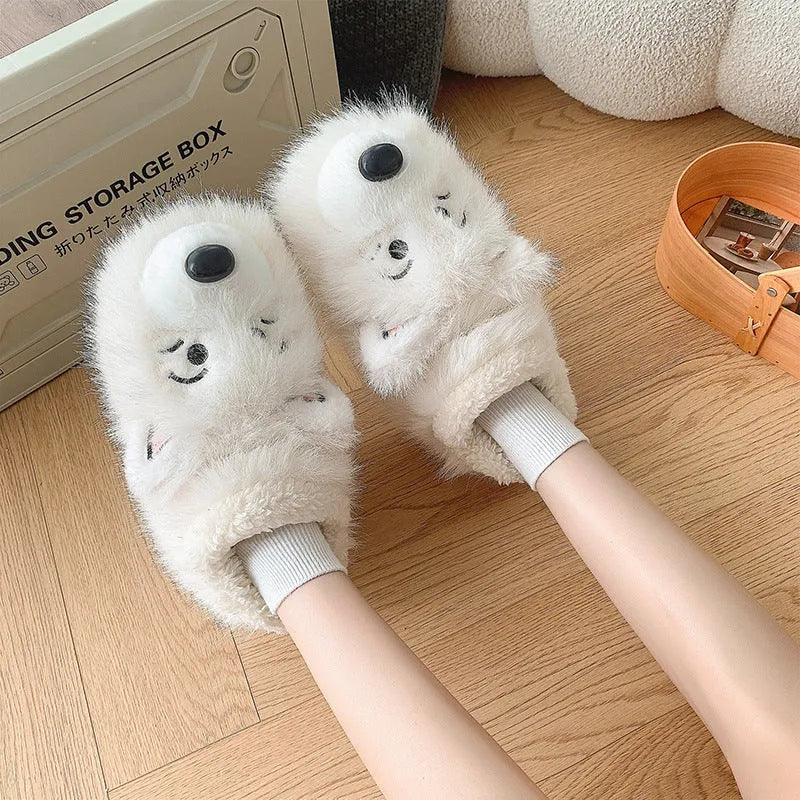 Grey ankle wrap slippers with a plush upper and a non-slip rubber sole, shown on a wooden floor.