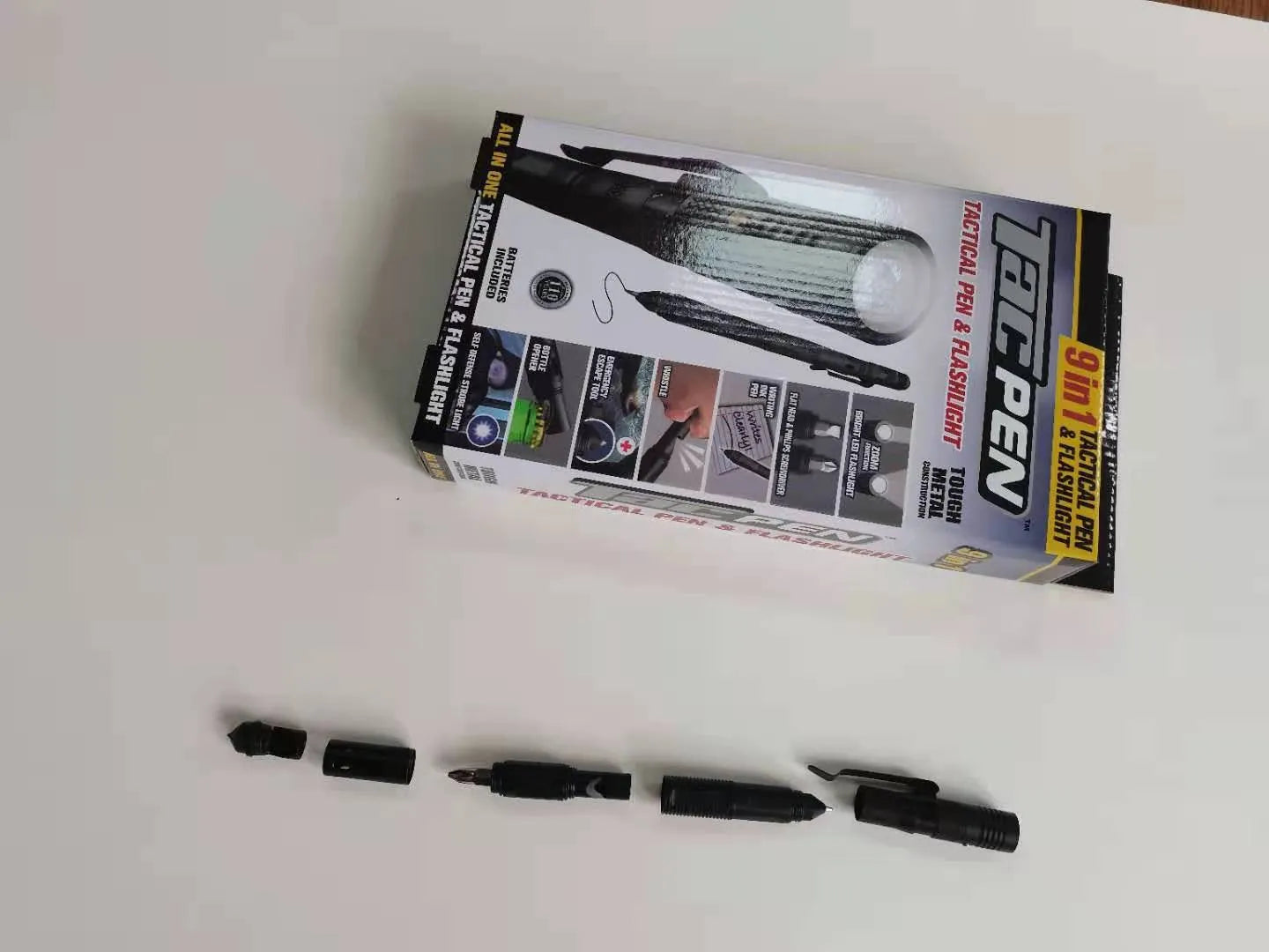 Nine-in-one multi-function flashlight survival pen in black with dual light sources and car window breaker