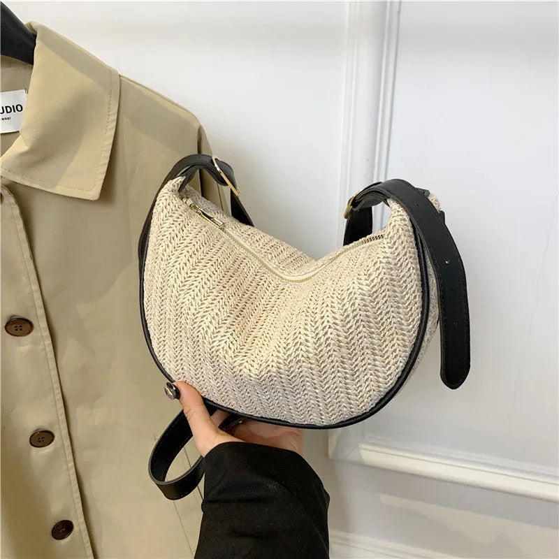 Women's woven straw crossbody bag showing internal phone pocket and document compartment
