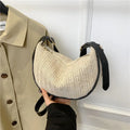 Women's woven straw crossbody bag showing internal phone pocket and document compartment