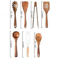A set of seven wooden kitchen utensils including spoons and spatulas arranged together.