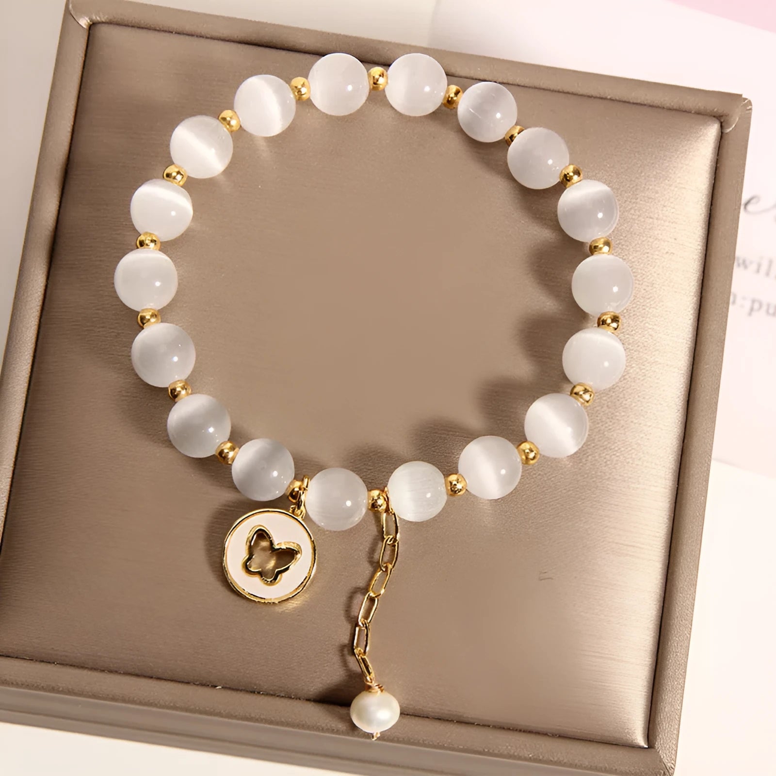 White Korean-style geometric bracelet with a cat's eye crystal on a stretch elastic band.