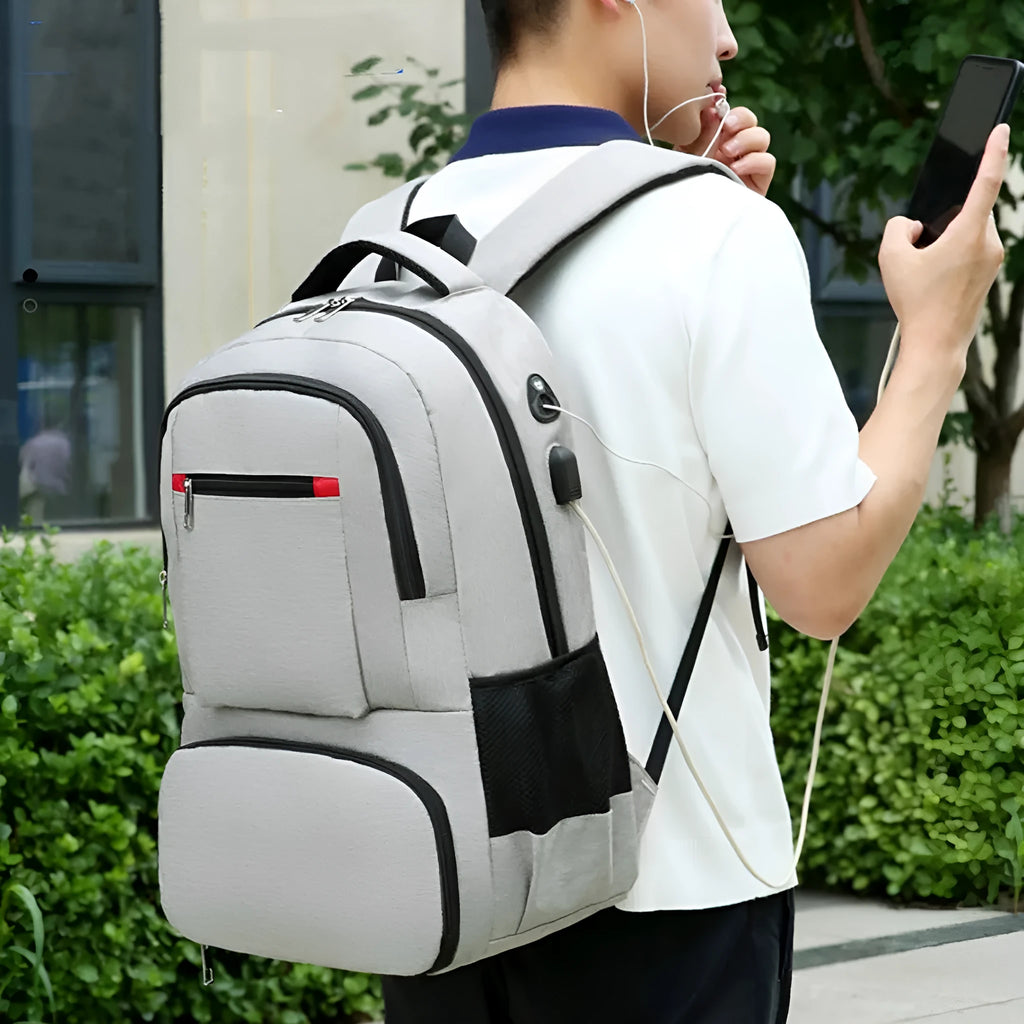 Light grey Oxford cloth insulated backpack with curved shoulder straps and a pull rod belt attached.