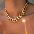 Gold thick chain necklace for women with a simple solid colour design.