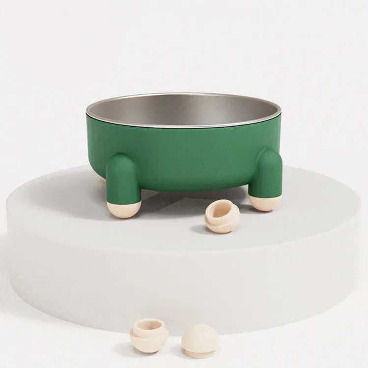 A green stainless steel pet bowl with a non-slip base and high foot, placed on a floor.