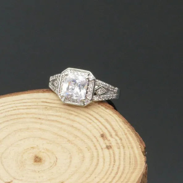 Geometric hollow zircon ring for women in platinum colour on copper, showing quadrilateral design and inlaid stones.