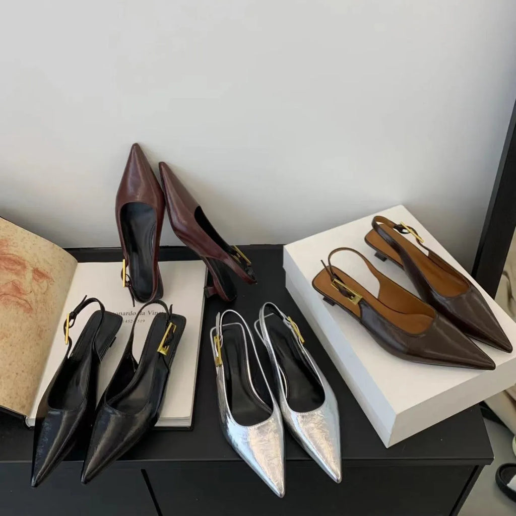 Thin low heel strap pointed leather shoes in black colour showing ankle strap and rubber sole