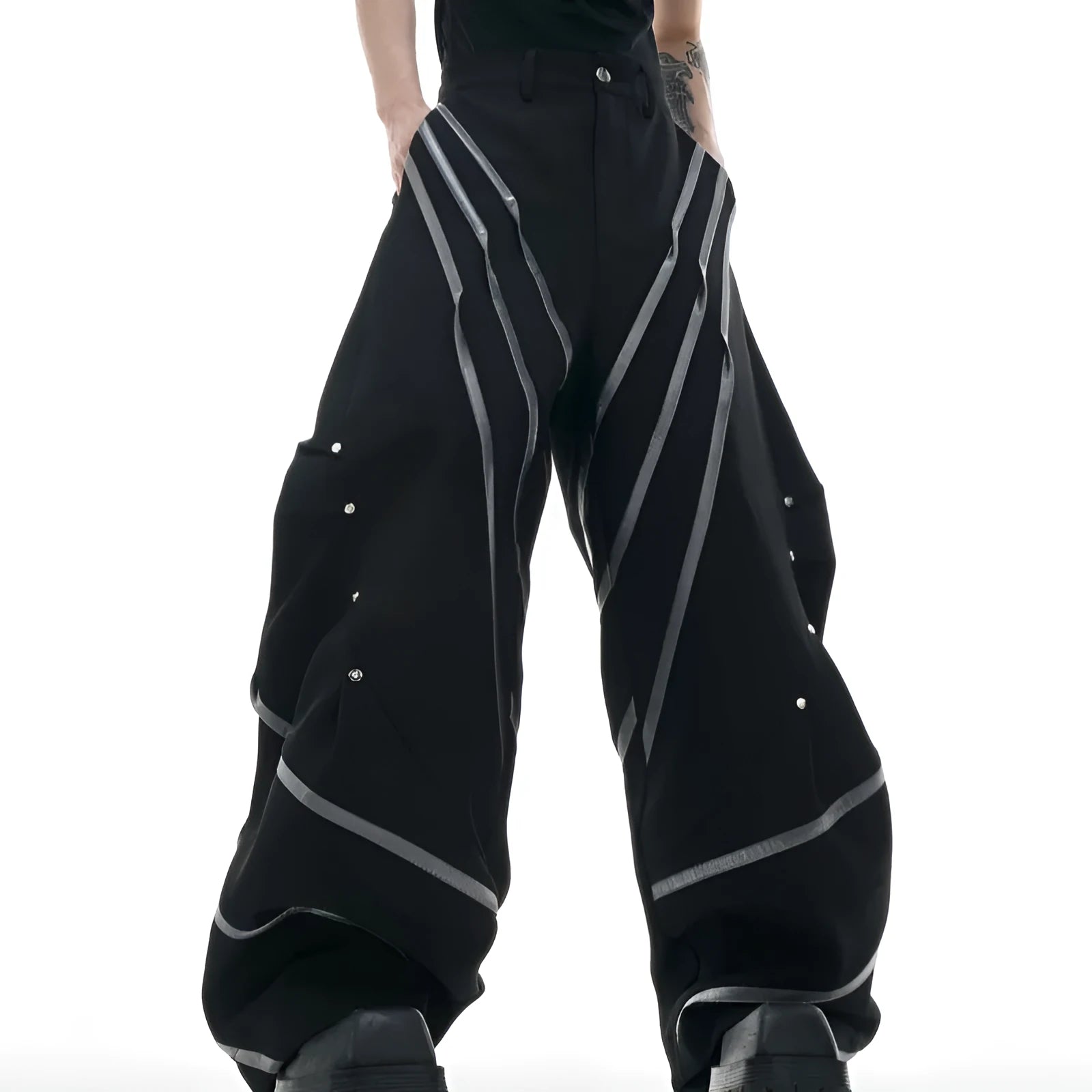 Men's black trousers with three-dimensional cut, metal striped rivets, and pleated detailing