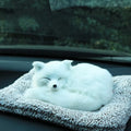 Fox bamboo charcoal car deodorant doll with grey hair and check pad on a car dashboard