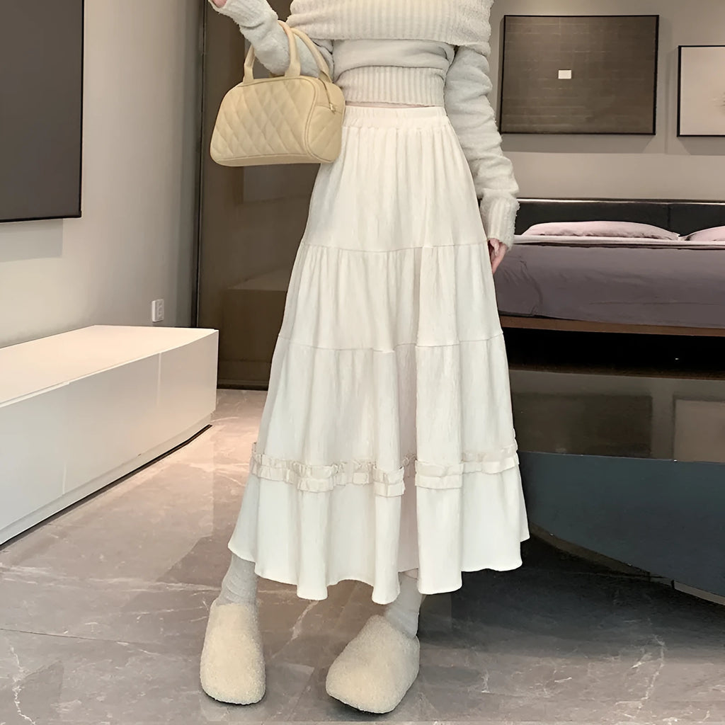 Women's beige corduroy A-line midi skirt with an elasticated waistband on a hanger.