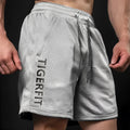 Men's light grey quick-dry mesh casual sports shorts with loose straight cut on a white background.
