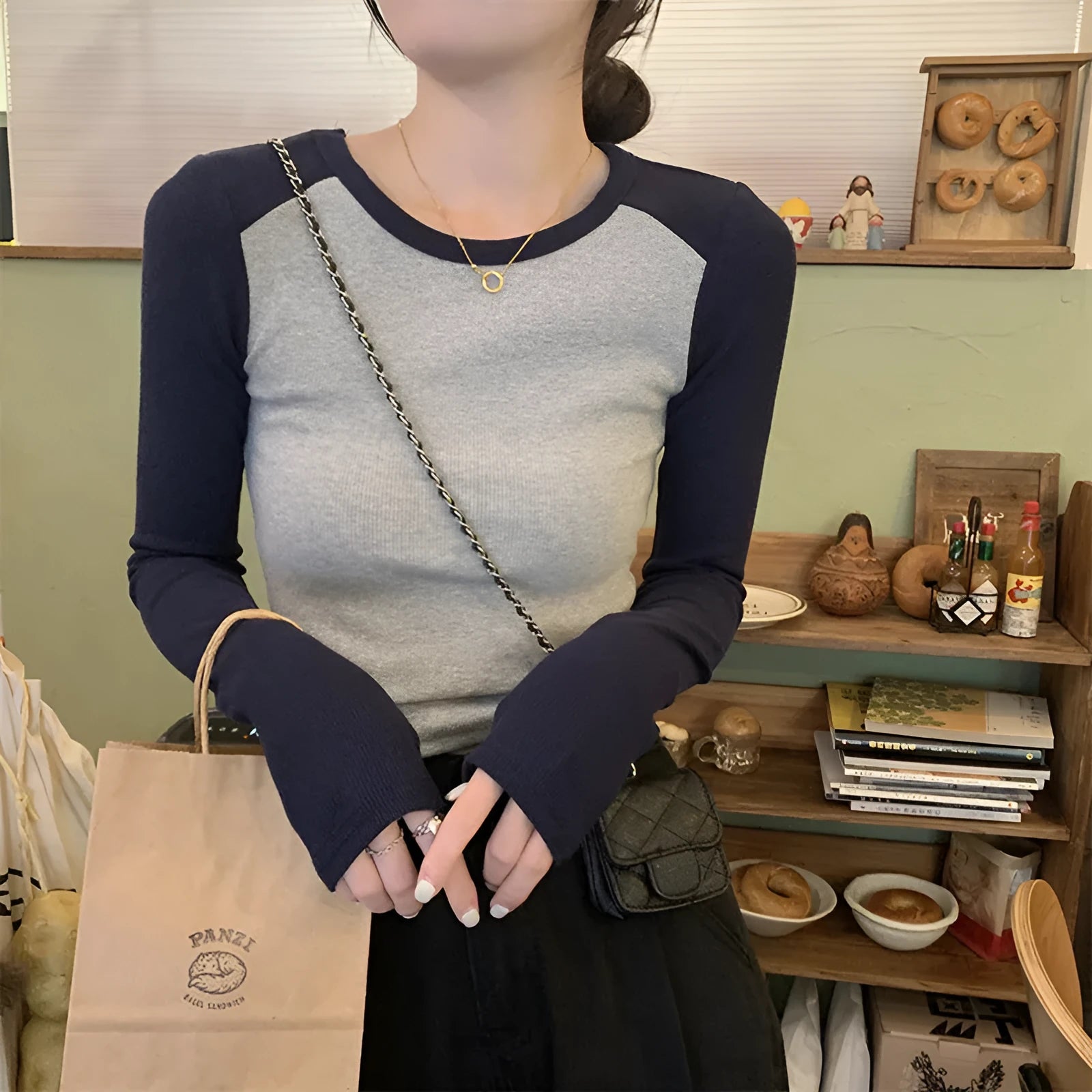 Dark blue women's oversized viscose top with embroidery and long princess sleeves on a hanger.
