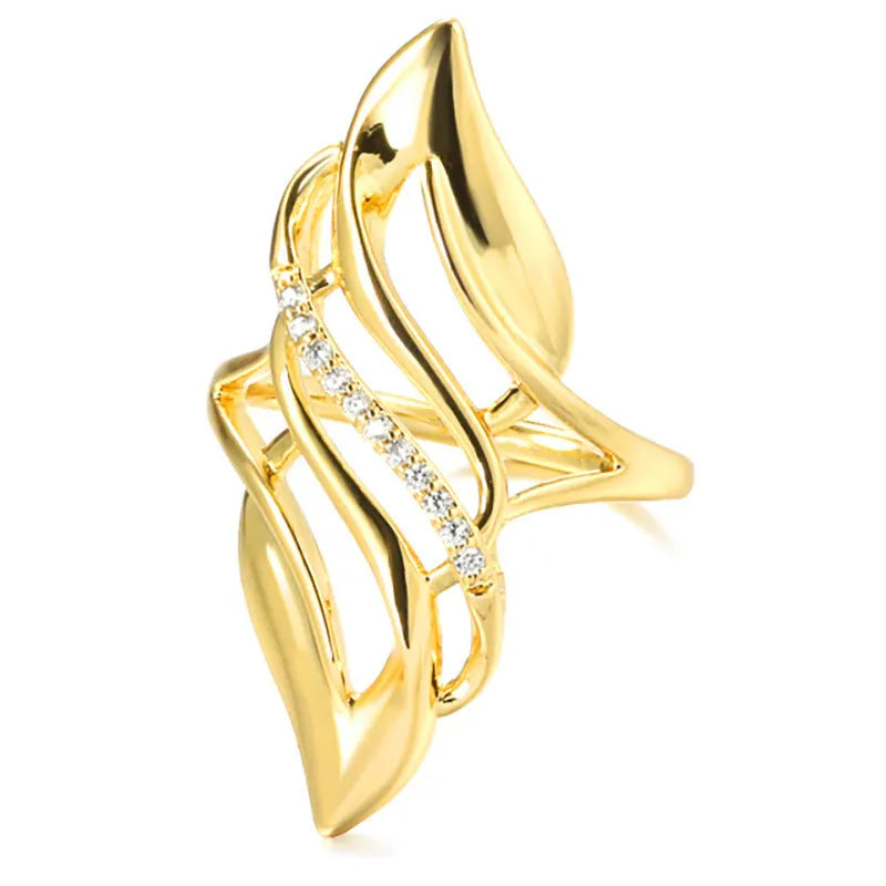 Gold-colour women's ring with exaggerated curved design and zircon crystal detail on a copper band.