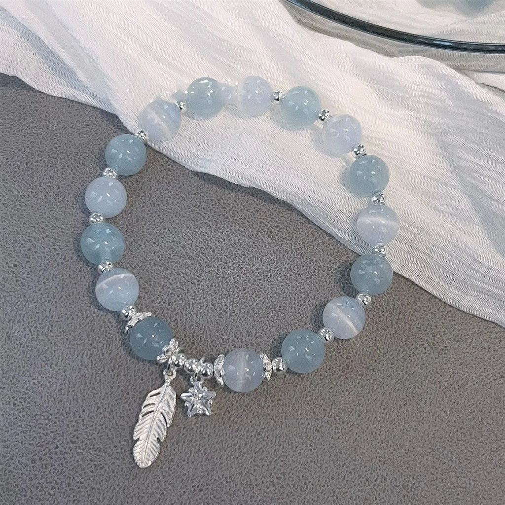 Glass crystal bracelet with coloured glaze in blue moonlight colour showing text modelling and eight-point star detail