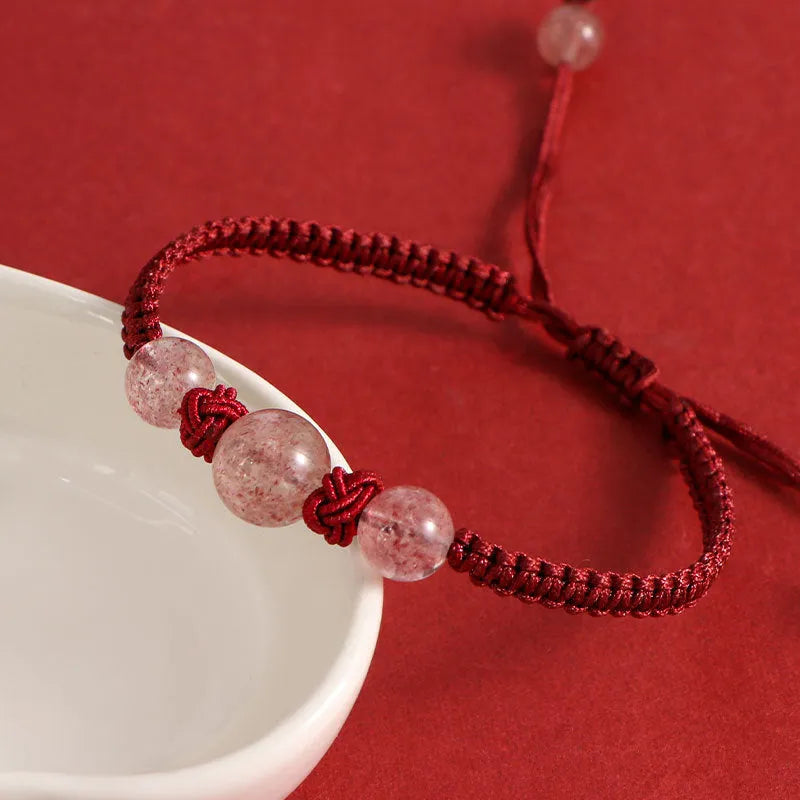 Woven red rope bracelet with natural strawberry quartz beads and alloy metal components