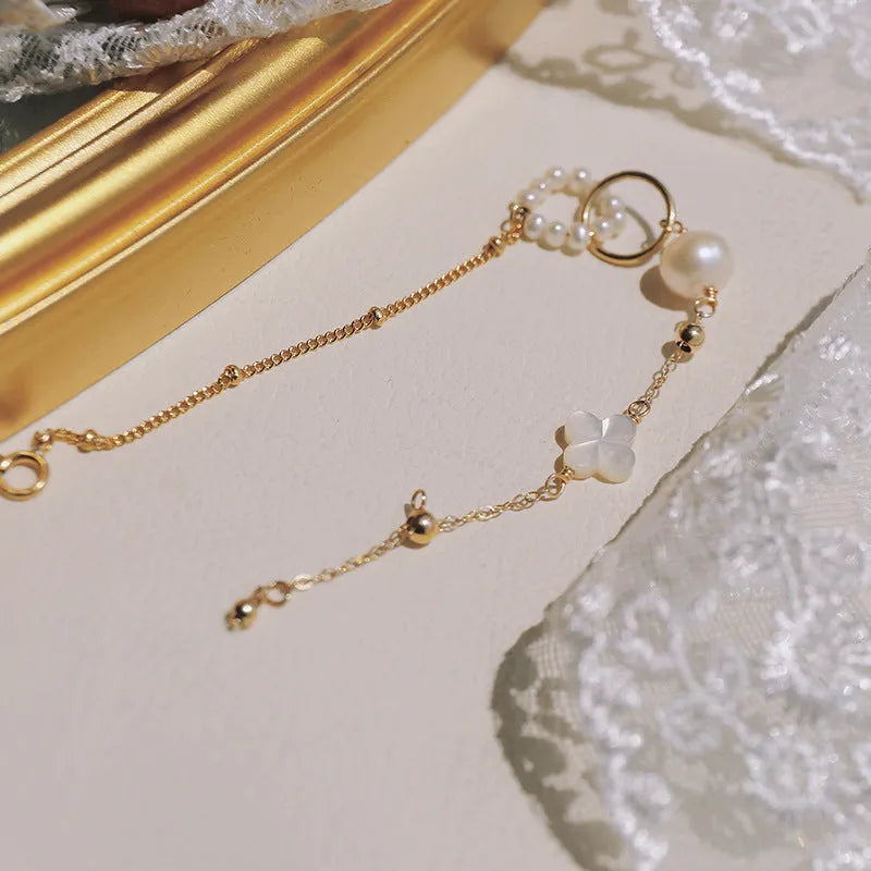 Women's natural pearl bracelet with 14k gold-plated clasp and chain.