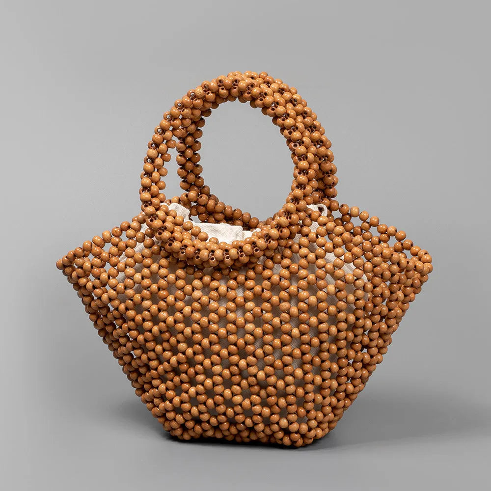 Hand-woven maple beach handbag with wooden beads in dumpling shape, shown in milky white colour
