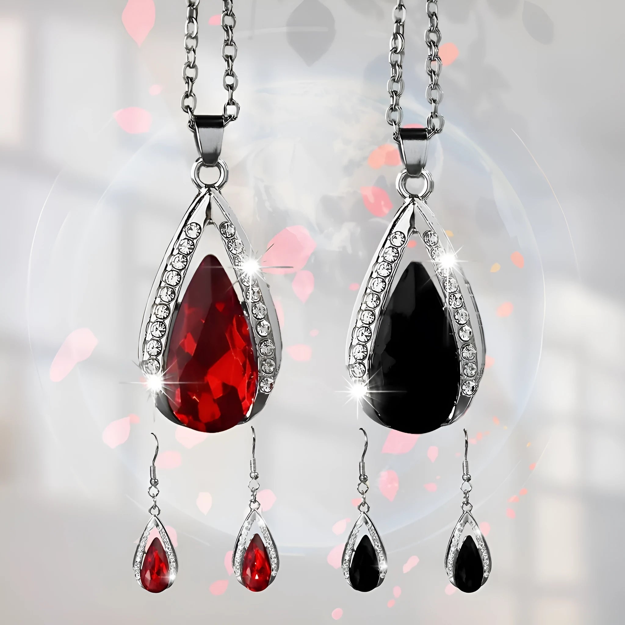 Black and red teardrop glass pendant necklace and matching earrings set on display.