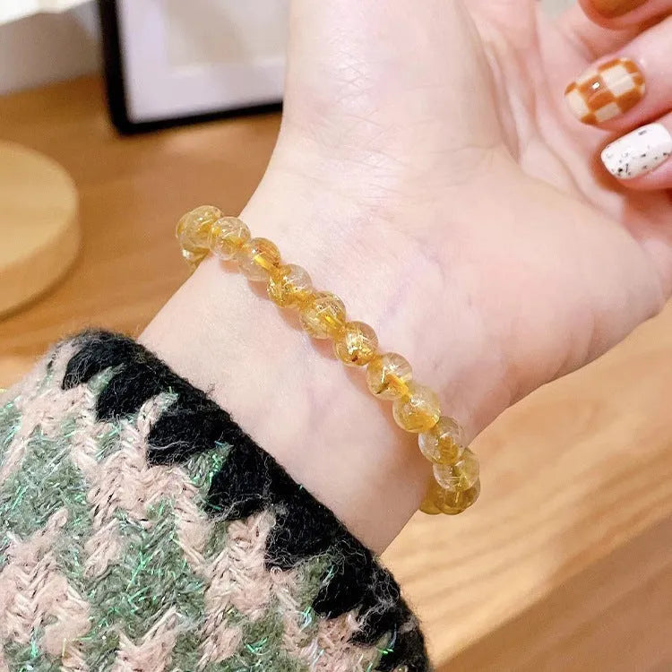Women's gold rutilated quartz sunstone crystal bracelet with diamond-shaped beads