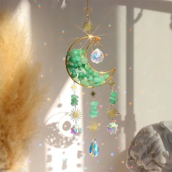 Car interior hanging pendant with large round crystal moon charm on a metal chain.