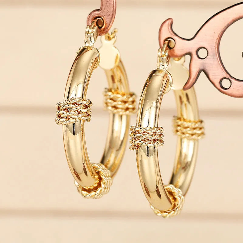 Geometric copper earrings for women featuring ring and line design in a golden colour.