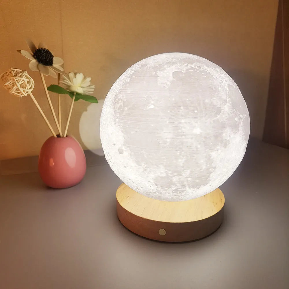 Rotating moon night lamp with wooden base showing three colour modes