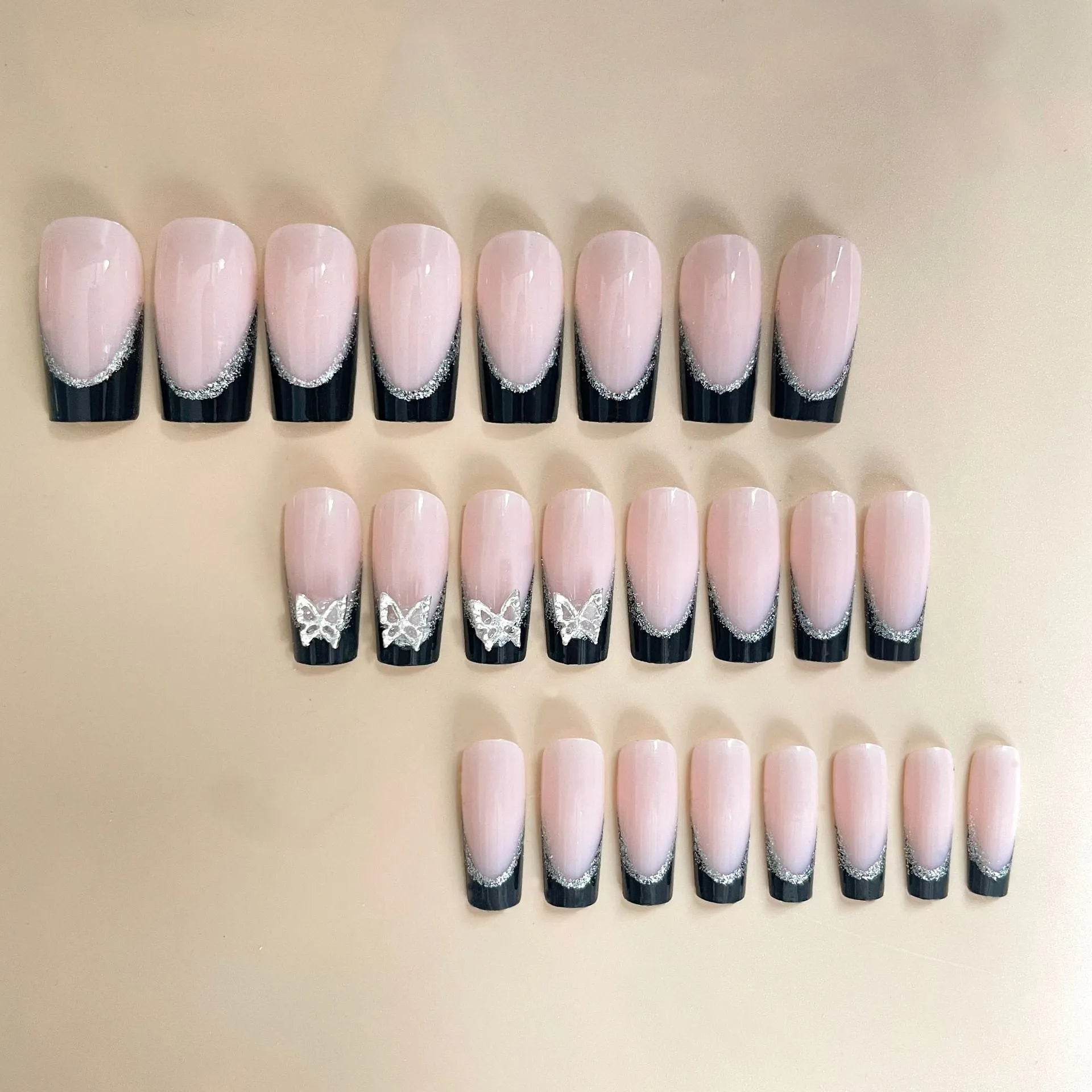 Black French-style glitter butterfly wear armour nail art set on a nail.