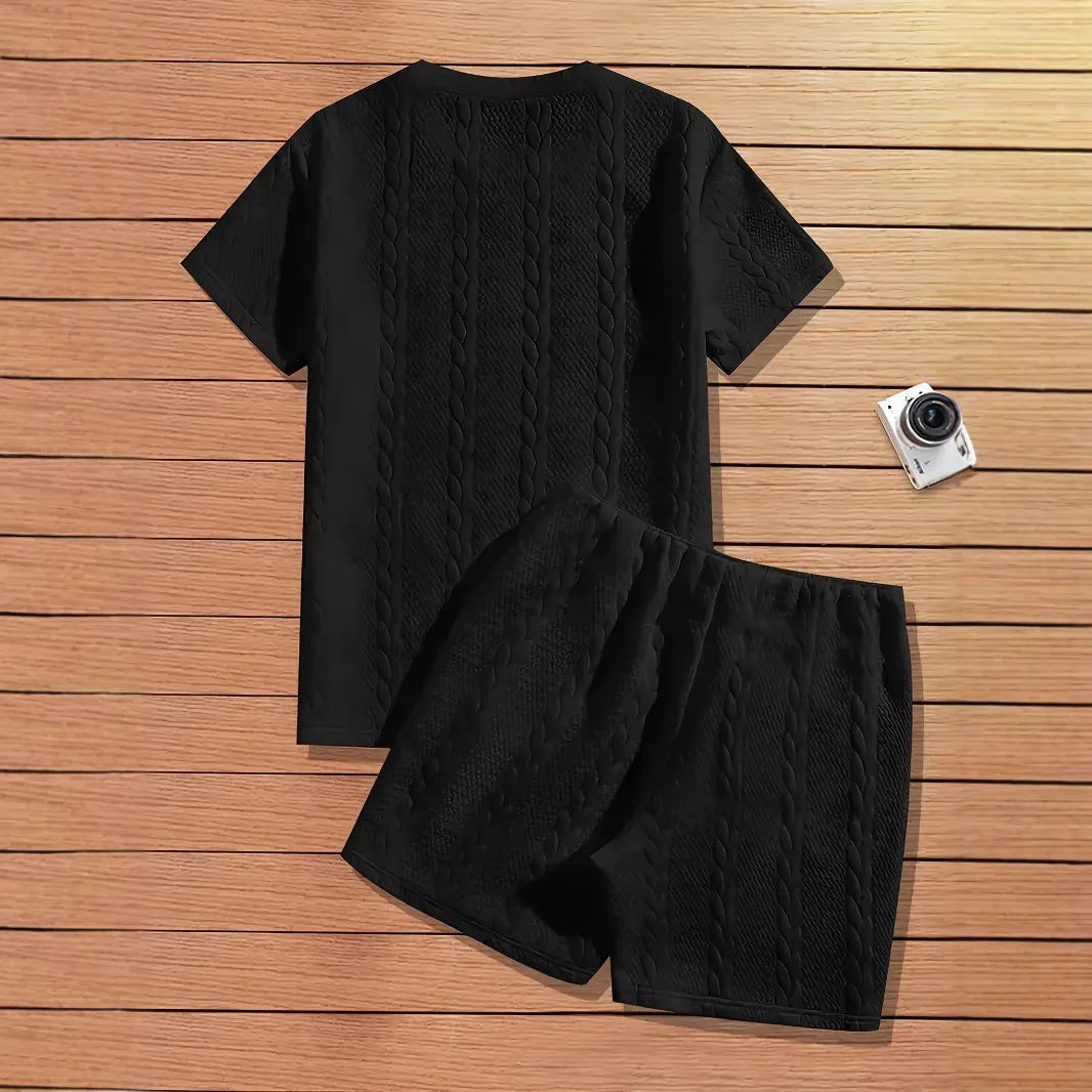 Men's black ribbed two-piece sports set with patch design on short sleeve top and matching shorts