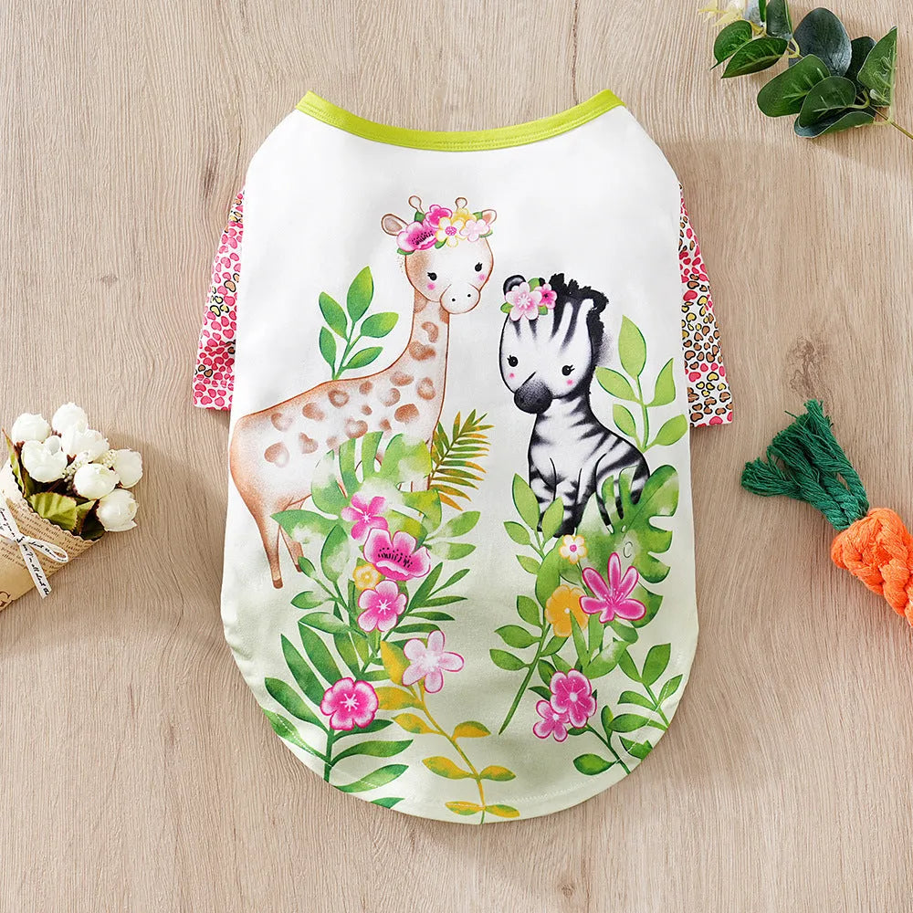 Colourful printed dog t-shirt on a small dog, showing the casual fit and full graphic design.