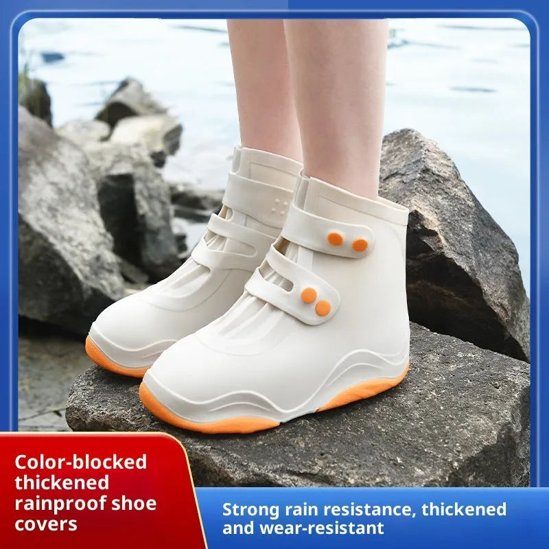 Set of waterproof silicone shoe covers in black, blue, orange, and white with non-slip soles
