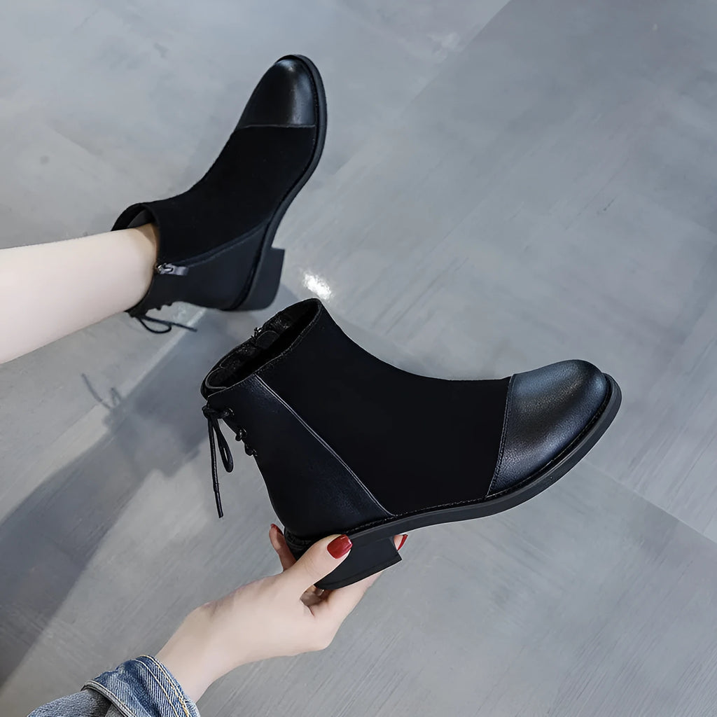 Black women's knee-high Martin boots with side zip and round toe.