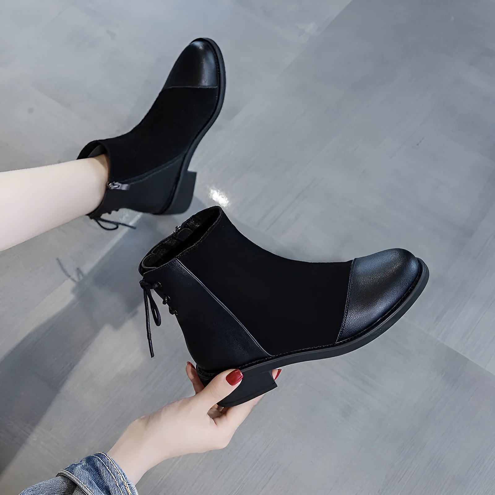 Black women's knee-high Martin boots with side zip and round toe.